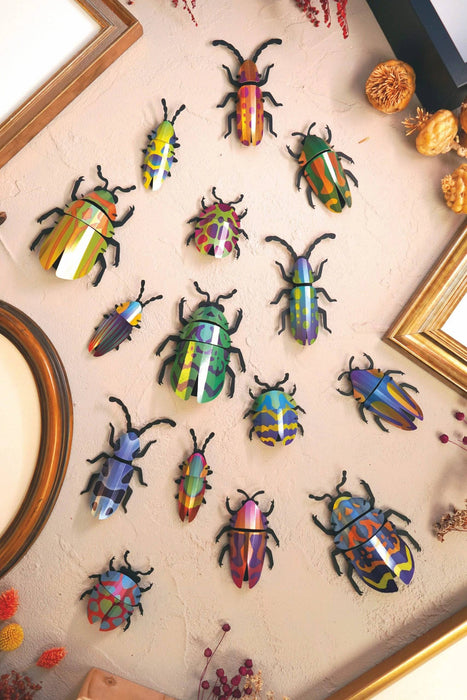 Green paper beetle craft from Assembli's Paper Beetle Collection, featuring folded paper and intricate insect details.