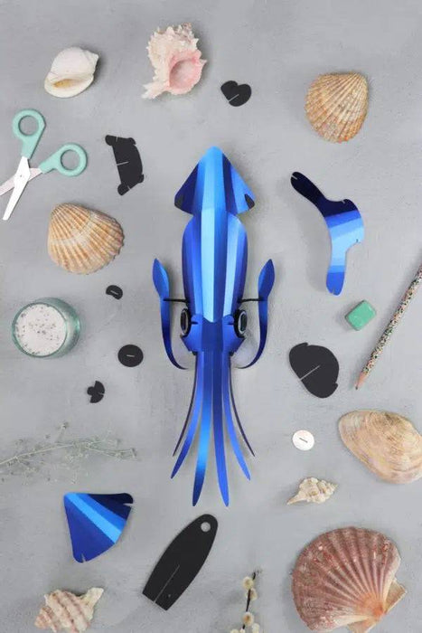 Pink paper craft squid made by Assembli, featuring detailed paper folds and a playful design for creative crafts.