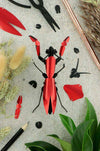 Assembli Paper Praying Mantis craft made from red metal and paper, showcasing detailed insect sculpture for arts and crafts projects.