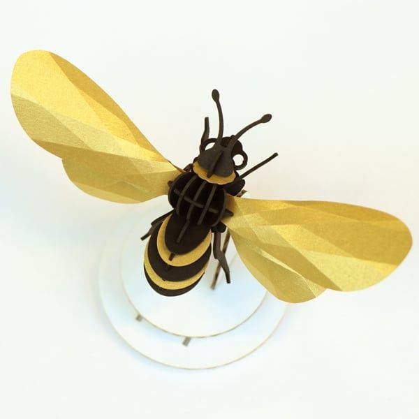 Gold satin paper honey bee craft by Assembli, featuring detailed bee shape made from shiny satin gold paper.