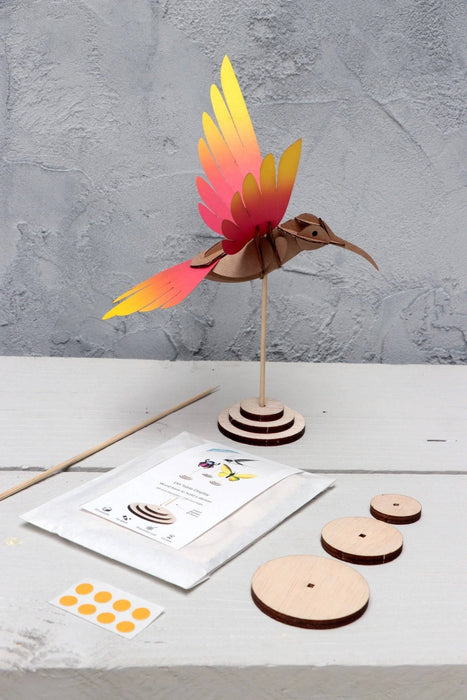 Yellow and blue paper craft of a colibri bird made by Assembli, showcasing colorful, artistic paper craft materials.