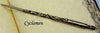 Bronze Papier Plume dipping pen with fleur-de-lys design, showcasing elegant craftsmanship and artistic calligraphy tools.