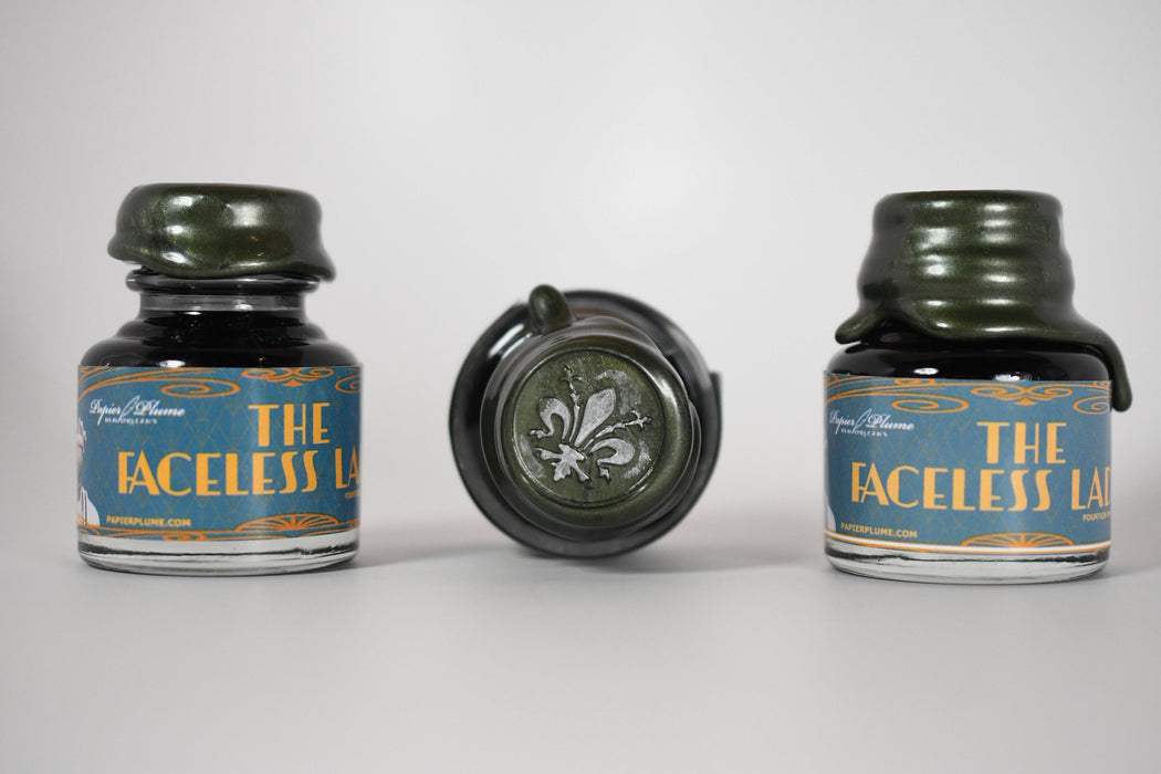 Papier Plume Chicago Pen Show Faceless Lady Shimmer Fountain Pen Ink bottle with label and decorative ink design.