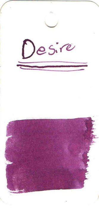 Papier Plume New Orleans Collection fountain pen ink bottle labeled Desire, showcasing elegant packaging and dark ink inside.