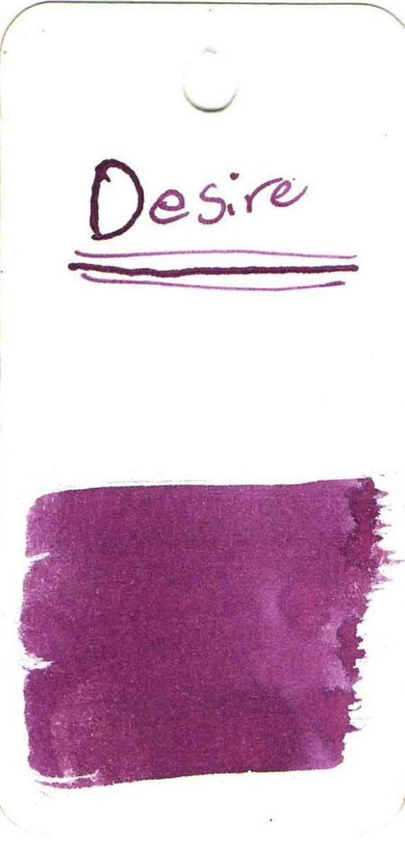Papier Plume New Orleans Collection fountain pen ink bottle labeled Desire, showcasing elegant packaging and dark ink inside.