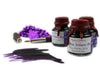Papier Plume New Orleans Collection fountain pen ink in vibrant Mardi Gras Indians purple, showcased in a glass ink bottle.