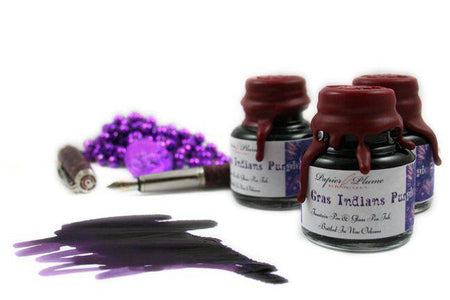Papier Plume New Orleans Collection fountain pen ink in vibrant Mardi Gras Indians purple, showcased in a glass ink bottle.