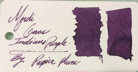 Papier Plume New Orleans Collection fountain pen ink in vibrant Mardi Gras Indians purple, shown in a glass ink bottle.