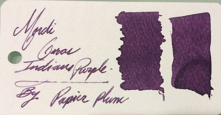 Papier Plume New Orleans Collection fountain pen ink in vibrant Mardi Gras Indians purple, shown in a glass ink bottle.