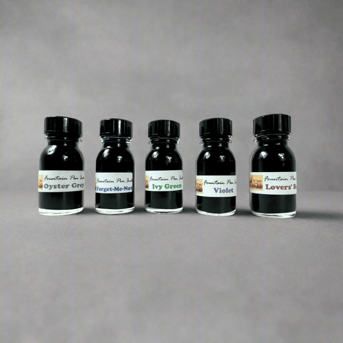 Papier Plume glass calligraphy pen set with elegant pens and ink bottles for writing and artistic lettering.