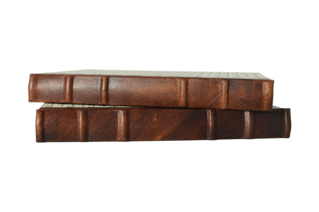 Handcrafted leather-trimmed journal with fleur de lys design and old world spine by Il Cartiglio, featuring lined pages.