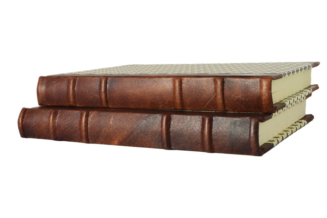 Handcrafted leather-trimmed journal with fleur de lys design and old world spine, by Il Cartiglio, featuring lined pages and vintage style.