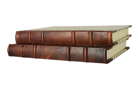 Handcrafted leather-trimmed journal with fleur de lys design and old world spine, by Il Cartiglio, featuring lined pages and vintage style.