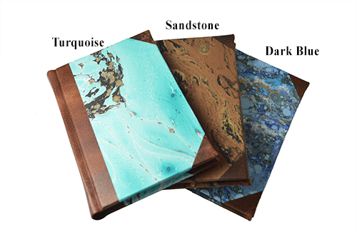 Handcrafted Il Cartiglio leather-trimmed journal with marbled paper and modern spine, featuring lined pages and turquoise cover.