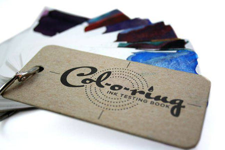 Col-O-Ring Ink Testing Book showing pages with ink samples and testing sections, used for evaluating ink colors and qualities.