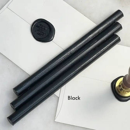 Black pliable sealing wax sticks by Papier Plume, 7 inches long, ideal for sealing and craft projects.