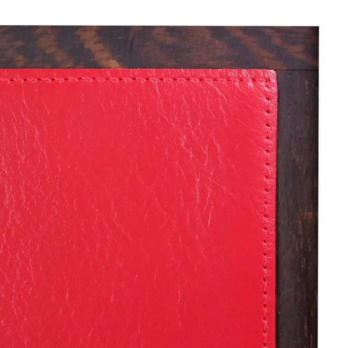 Red Atelier De La Foret 11-pen box featuring a sleek, compact design for organizing and storing pens and writing instruments.