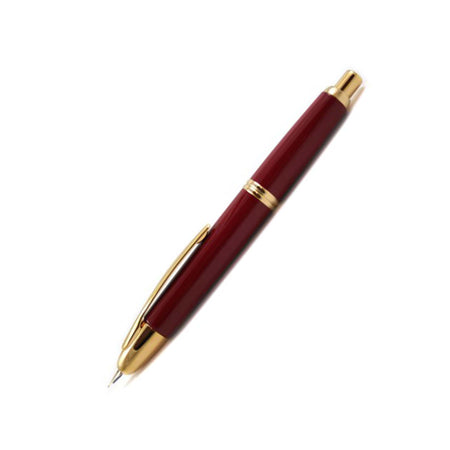 Pilot Vanishing Point fountain pen in red and gold with a sleek design and extra-fine nib, ideal for smooth writing.