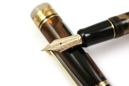 Pilot Custom 823 fountain pen in amber with fine nib, showcasing its elegant design and smooth ink flow.