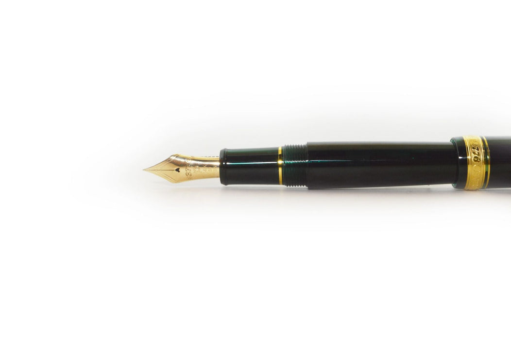 Platinum #3776 Century Laurel Green fountain pen with gold accents and transparent green cap, showcasing fine nib and elegant design.