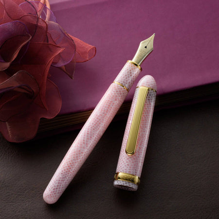 Platinum #3776 Century fountain pen with cherry blossom celluloid barrel and fine nib, showcasing elegant writing instrument design.