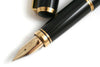 Platinum Maki-e fountain pen featuring intricate koi fish goldfish design with gold accents on a smooth black body.