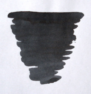 Diamine Quartz Black bottled fountain pen ink in a glass bottle with black ink visible inside.