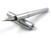 Rebecca Moss Turbo Fountain Pen with black ink barrel and silver accents, showcasing its sleek design and fine writing tip.