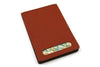 San Lorenzo regenerated leather memo pad cover in vibrant orange, showcasing smooth texture and sleek design.