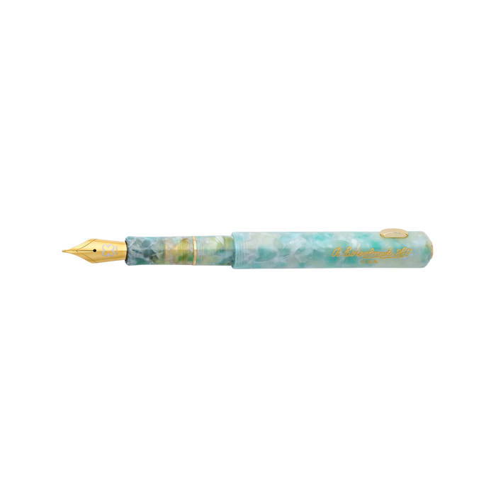 Esterbrook Niblet fountain pen with open blue ink nib and transparent barrel, showcasing elegant design and fine writing tip.