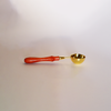 Small gold Papier Plume wax melting spoon with a smooth handle and rounded bowl for easy wax application.