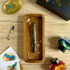 Esterbrook x BUNGUBOX Kingfisher Limited Edition Estie fountain pen with vibrant blue ink on a white background.