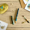 Esterbrook x BUNGUBOX Kingfisher Limited Edition Estie fountain pen with blue and gold accents on a white background.