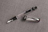 Twsbi Diamond 580AL R black fountain pen with metal clip and fine nib, showcasing its sleek design and textured black finish.