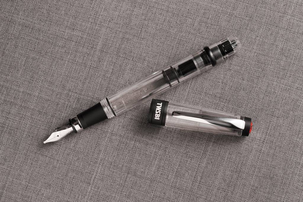 Twsbi Diamond 580AL R black fountain pen with metal clip and fine nib, showcasing its sleek design and textured black finish.