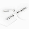 Twsbi Diamond 580 Clear fountain pen with transparent body and gold accents, displaying the fine nib and sleek design.