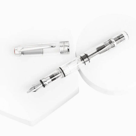 Twsbi Diamond 580 Clear fountain pen with transparent body and gold accents, displaying the fine nib and sleek design.