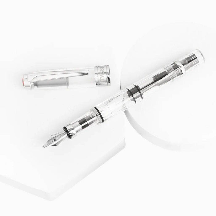Twsbi Diamond 580 Clear fountain pen with transparent body and gold accents, displaying the fine nib and sleek design.