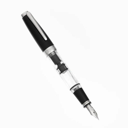 Twsbi Diamond Mini Classic fountain pen with gold accents and black resin body, shown with cap on and fine nib visible.