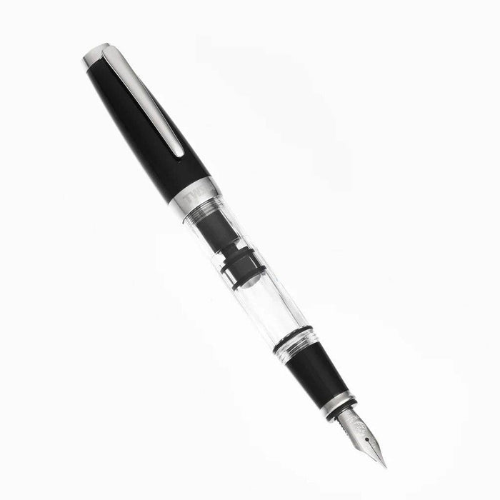 Twsbi Diamond Mini Classic fountain pen with gold accents and black resin body, shown with cap on and fine nib visible.