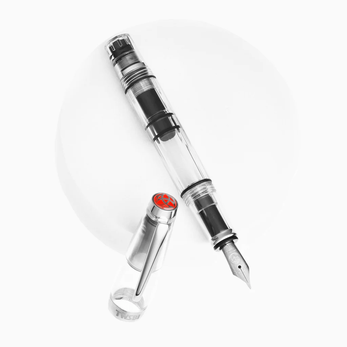 Twsbi Diamond Mini Clear fountain pen with transparent body and fine nib, showcasing its elegant design and compact size.