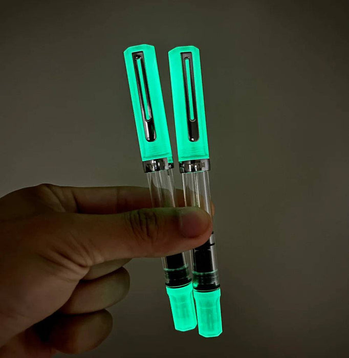 Twsbi Eco Glow Green fountain pen with an elegant green body and fine nib, showcasing its sleek design and craftsmanship.