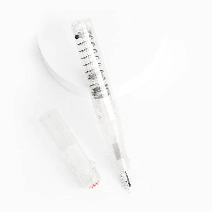 Twsbi Go Clear fountain pen with transparent body and fine nib, showcasing its sleek design and ink reservoir.