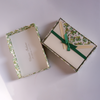 Green Florentine Rossi notecards showing elegant floral and geometric patterns on textured stationery with handwritten notes.