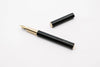 Black Y Studio Revolve fountain pen with fine nib, featuring sleek design and smooth ink flow.