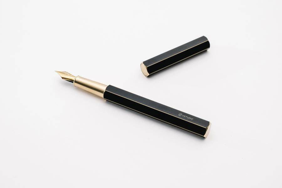 Black Y Studio Revolve fountain pen with fine nib, featuring sleek design and smooth ink flow.